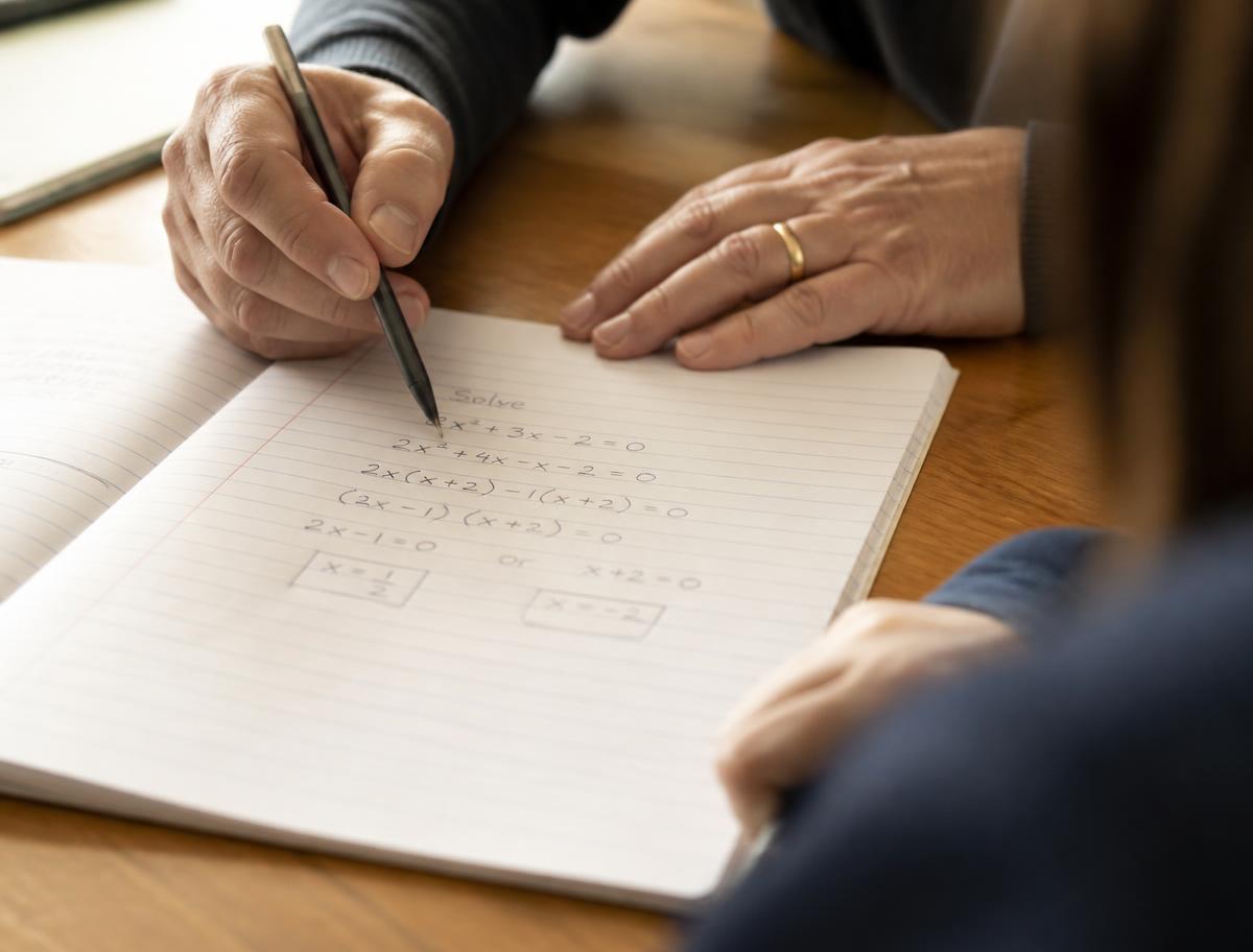 A tutor working through a mathematics problem with a student